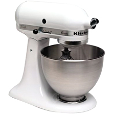 White stand mixer with a working bowl and a wire whip