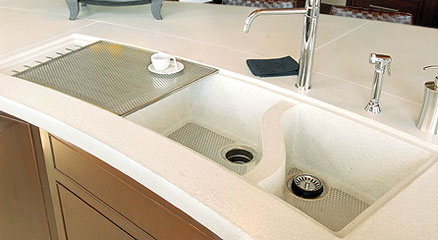 White concrete countertop and sink with brown cabinets