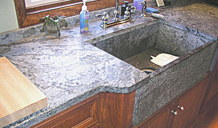 Soapstone countertop and sink with wood cabinets