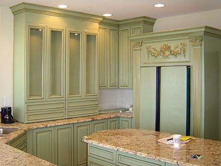 Light green antique kitchen cabinets in combination with natural stone countertops