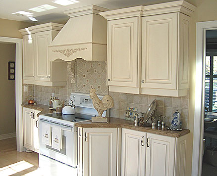 French country kitchen cabinets in combination with stone countertops and tile backsplash