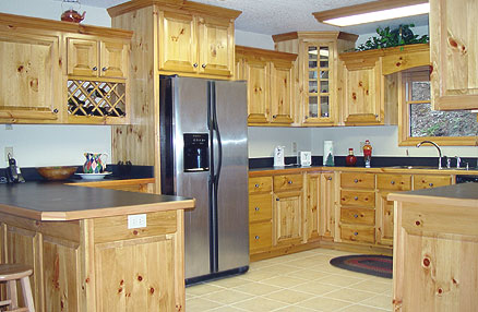 Nice big kitchen with knotty pine kitchen cabinets, stainless steel appliances and tile floor