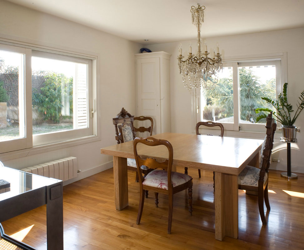 A dining area with a table and chairs.