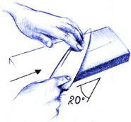 Sharpening a knife using a sharpening stone.